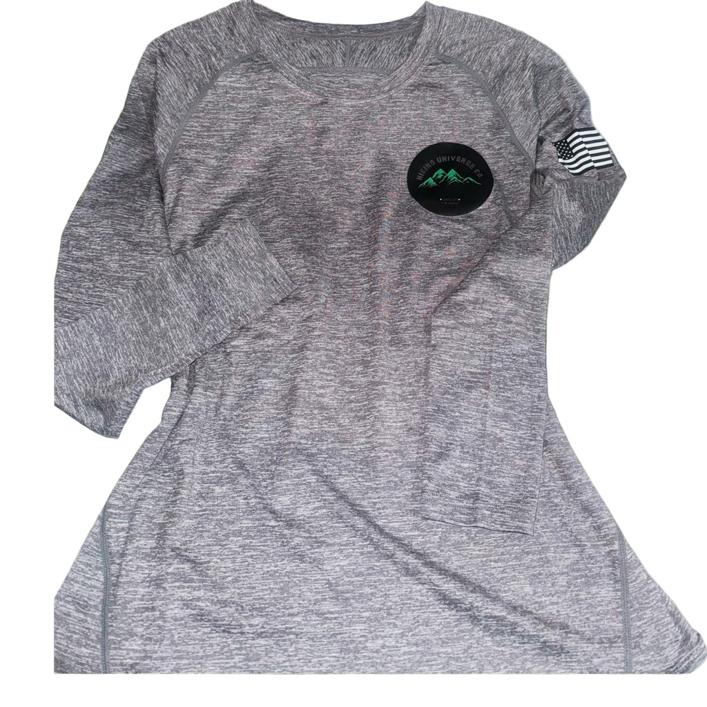 Gray athletic shirt with a black patch and American flag sleeve on grass