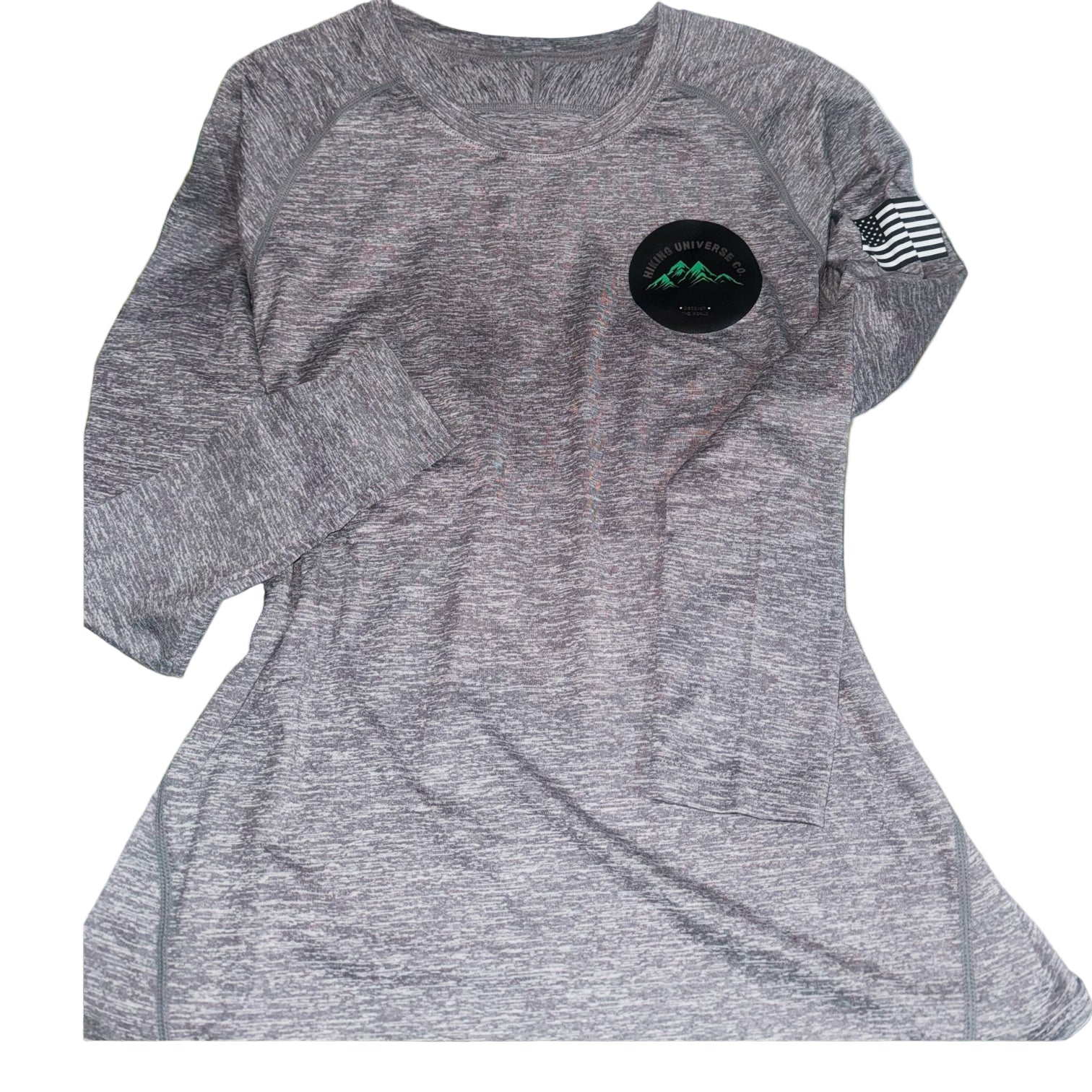 Gray athletic shirt with a black patch and American flag sleeve on grass