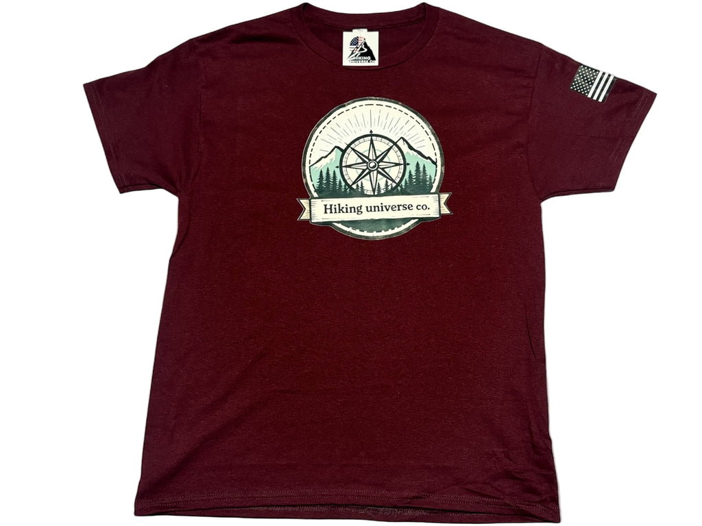 Maroon t-shirt with a circular logo featuring trees and mountains on a white background