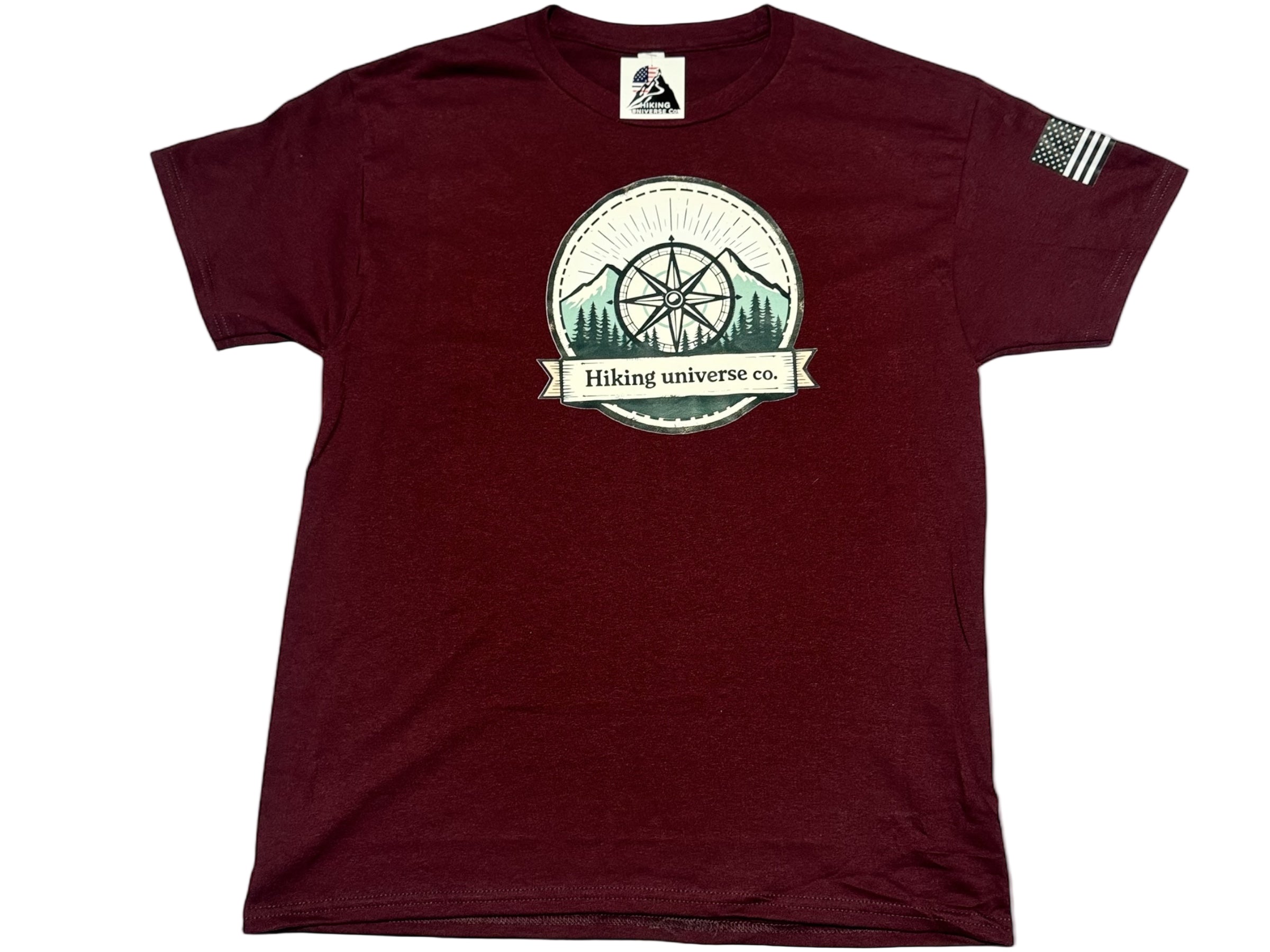 Maroon t-shirt with a circular logo featuring trees and mountains on a white background