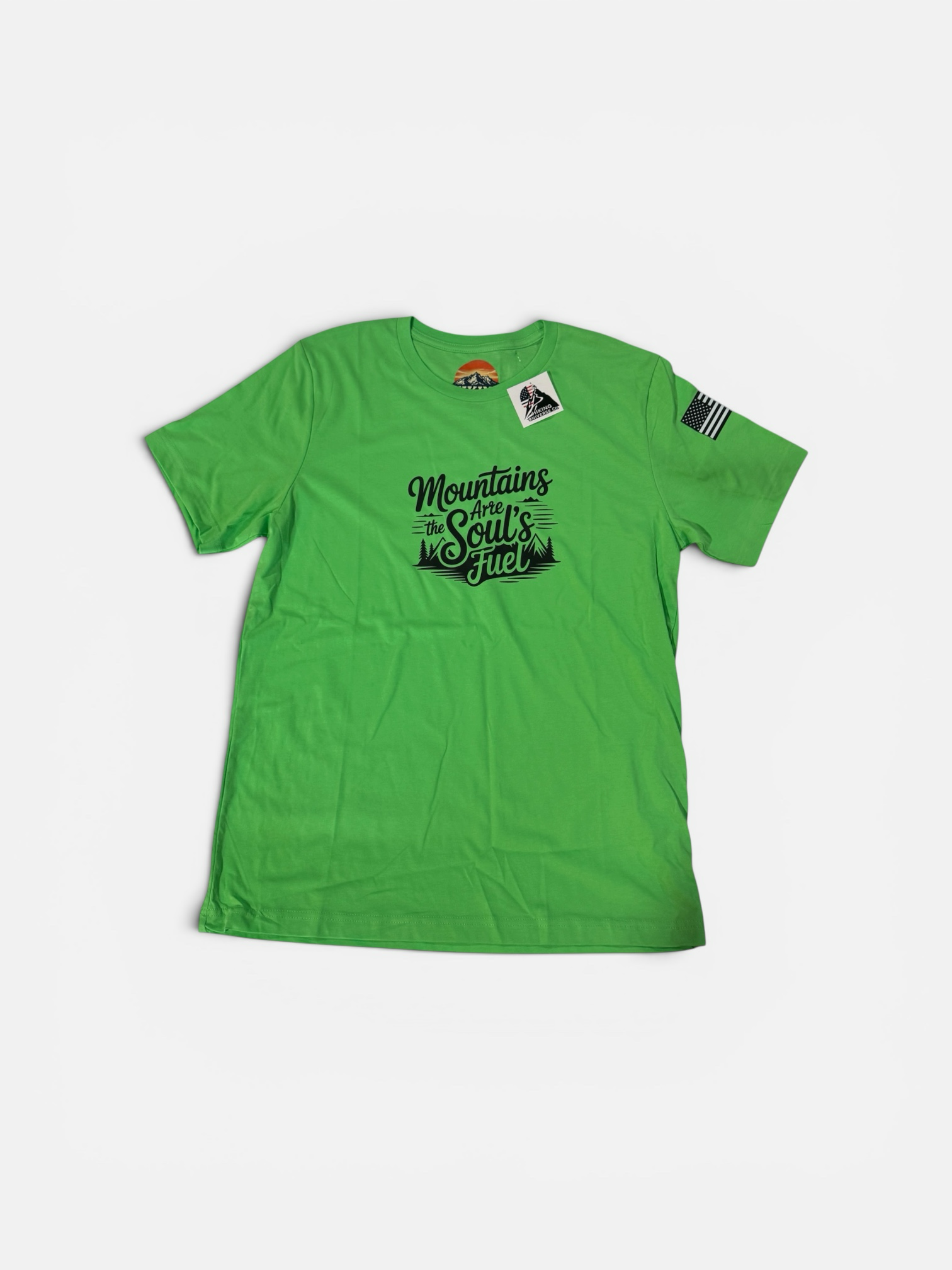 HIKING UNIVERSE CO. green cotton t-shirt with "Mountains Are The Soul's Fuel" graphic and an American flag patch on the sleeve.